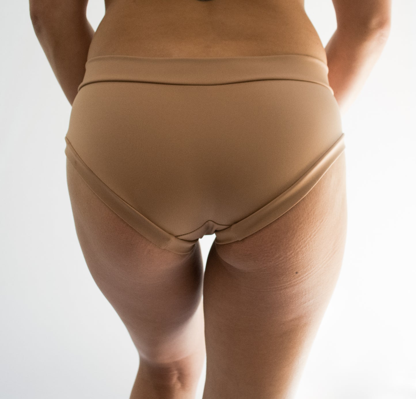 back view of nude colored pole dancing shorts 